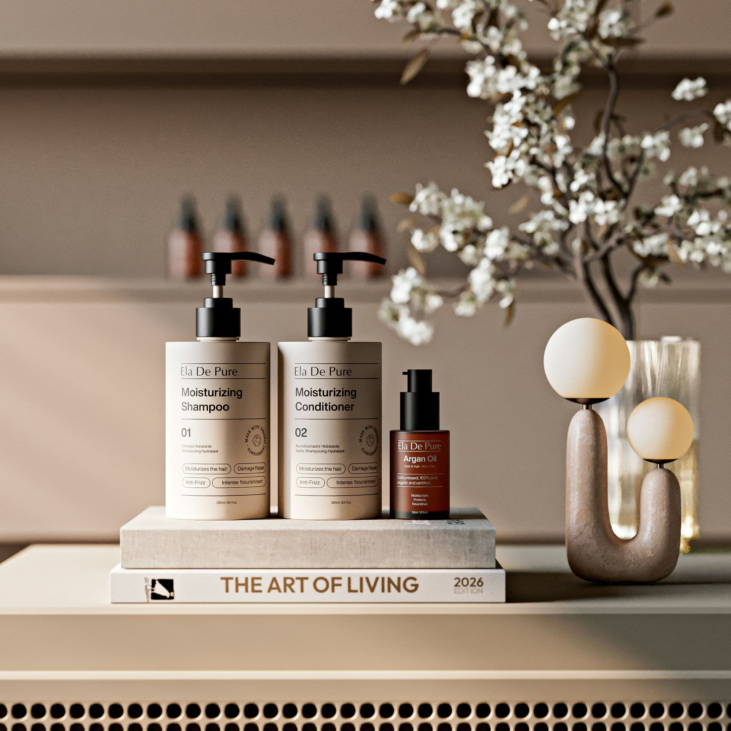 Styled haircare bottles beside a vase of blossom
