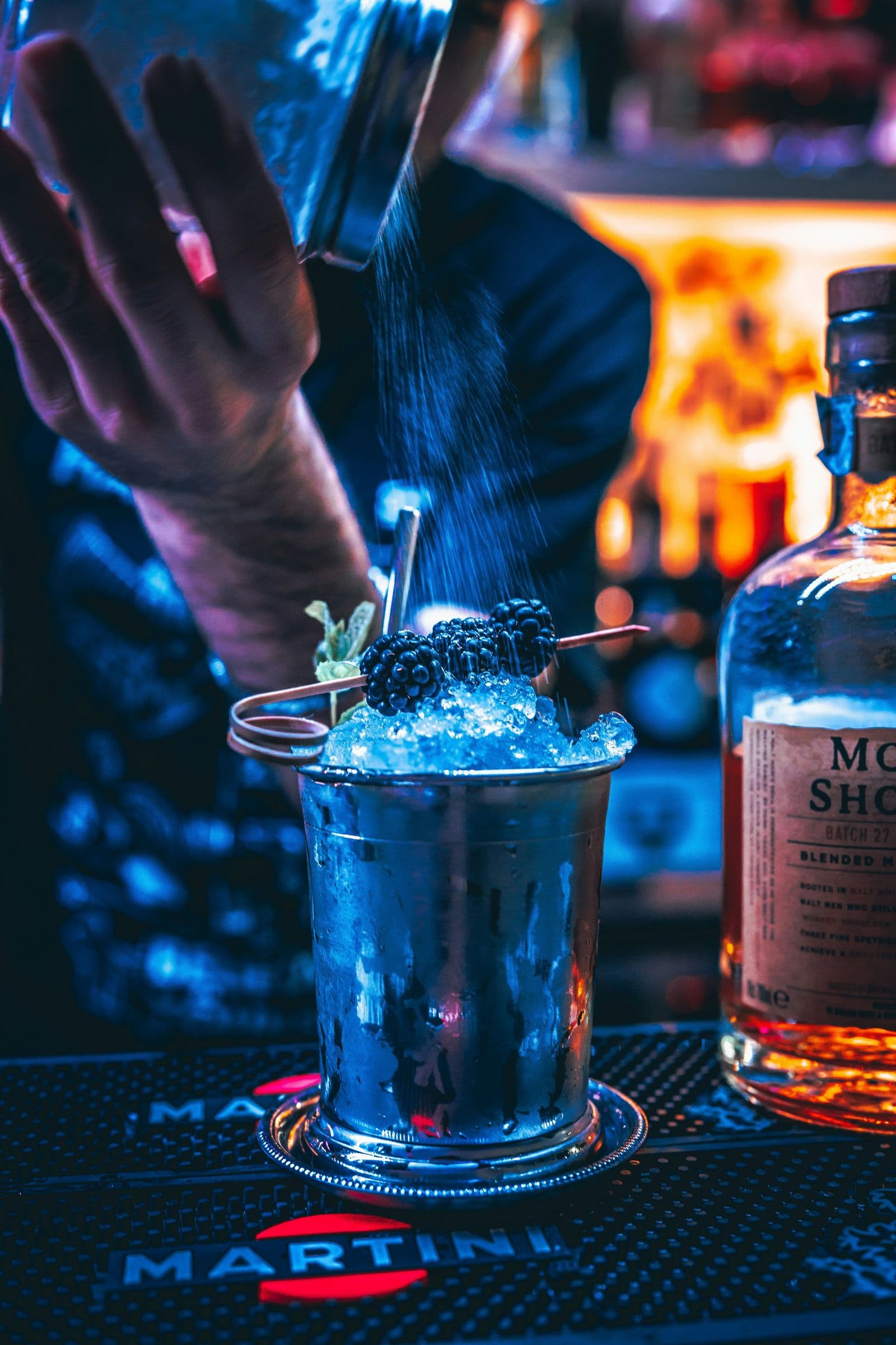 Bartender finishing a blackberry cocktail