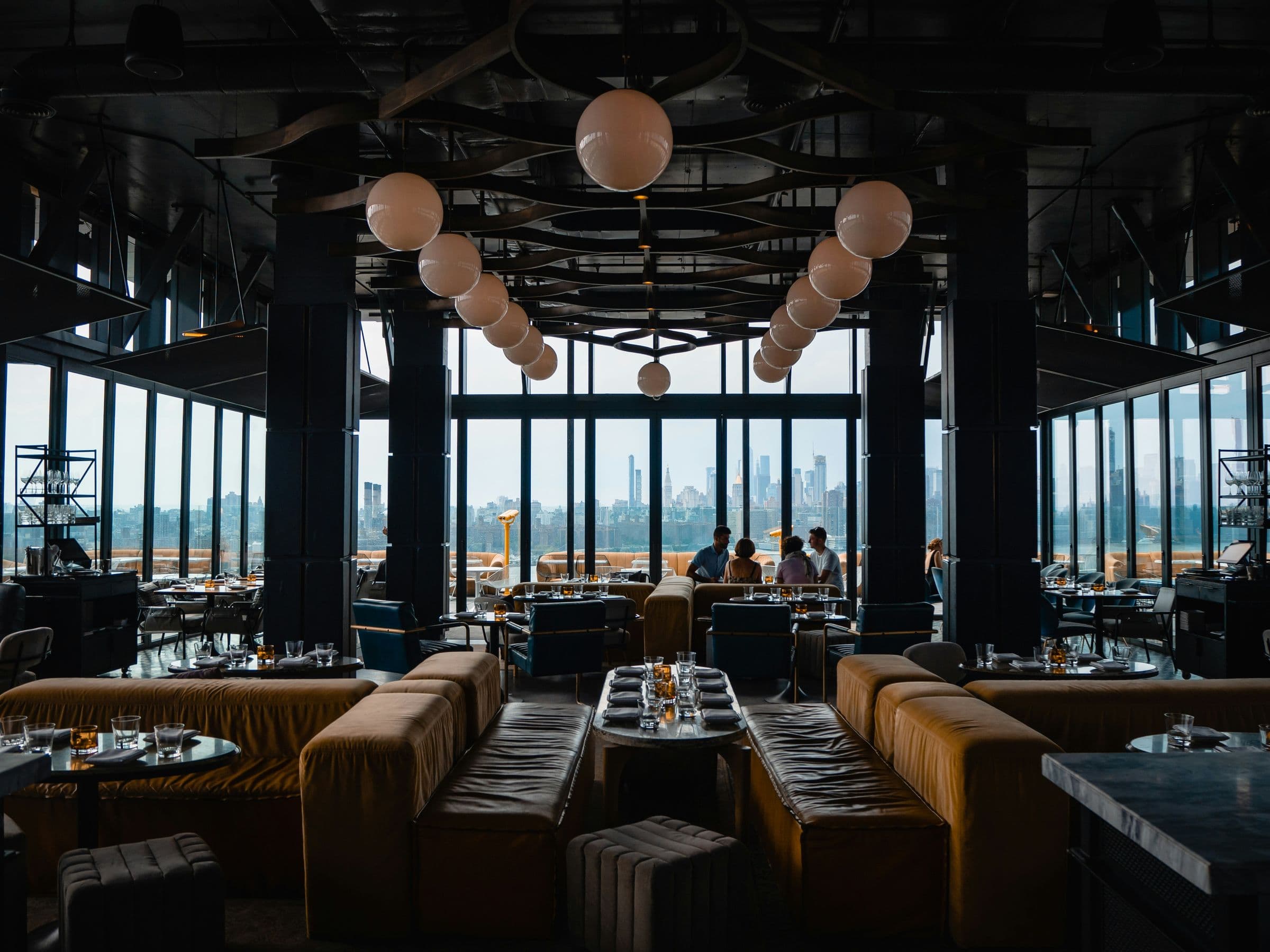 Restaurant with banquettes and floor-to-ceiling skyline views