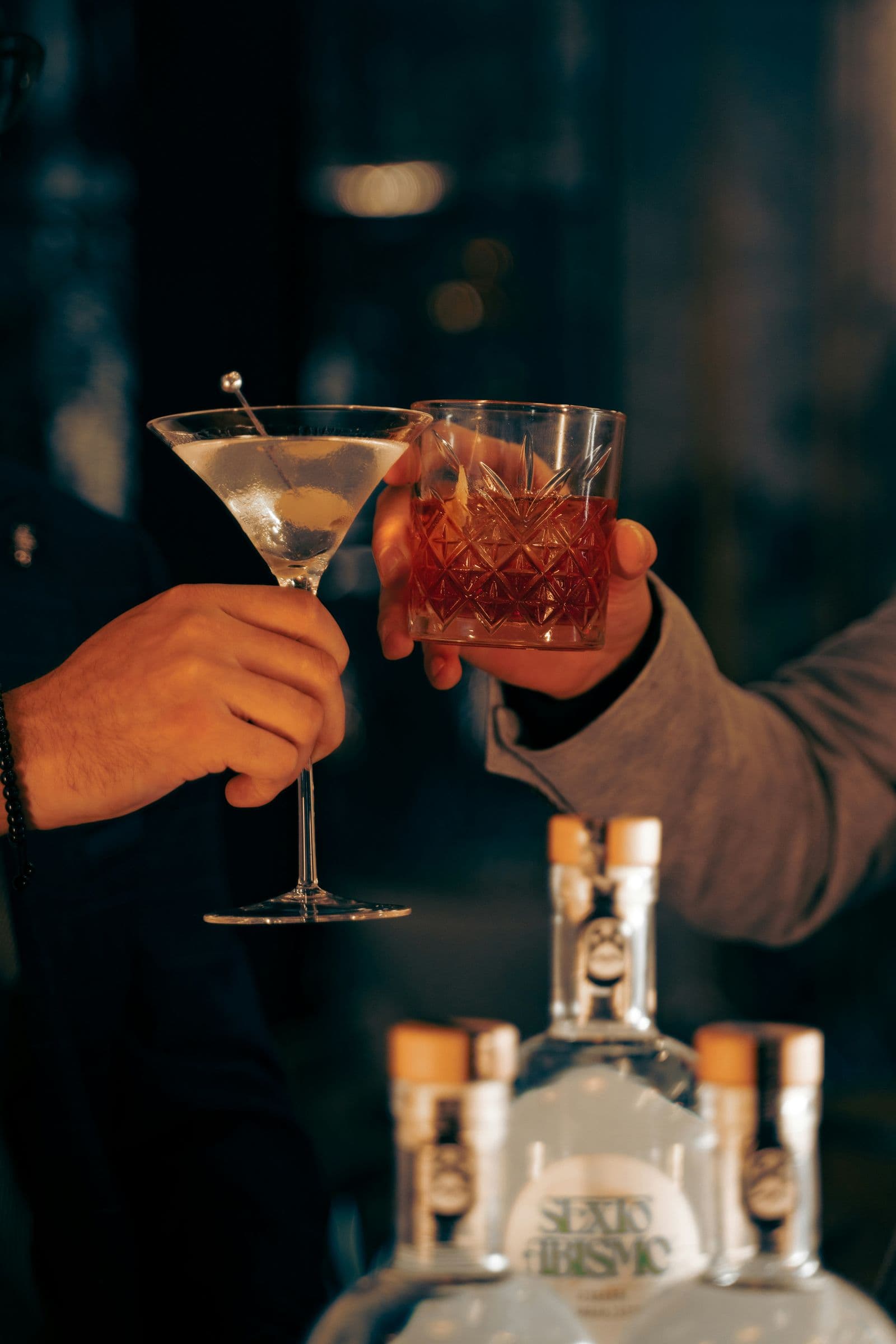 Two guests toasting with cocktails