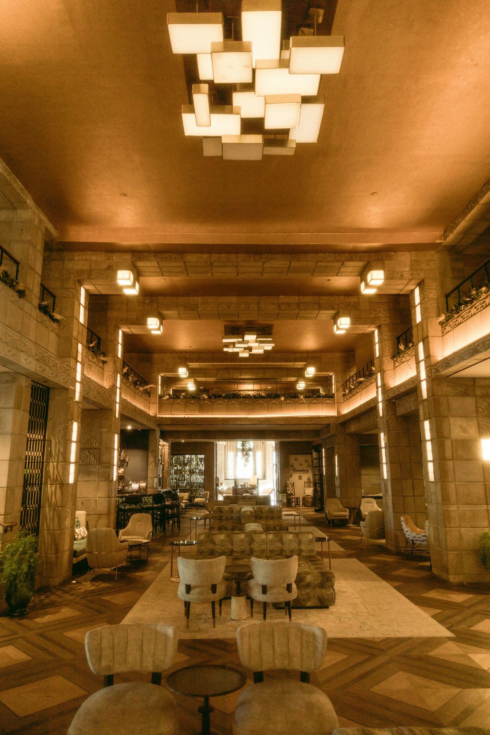 Golden, double-height hotel lobby