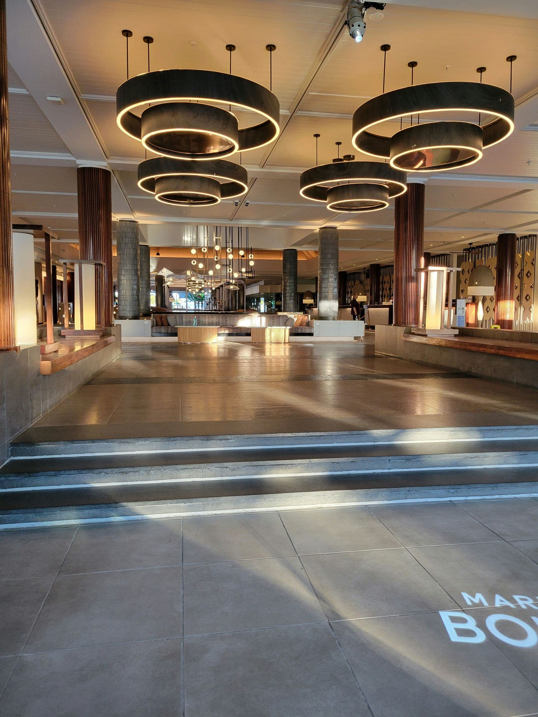 Grand hotel lobby with circular chandeliers