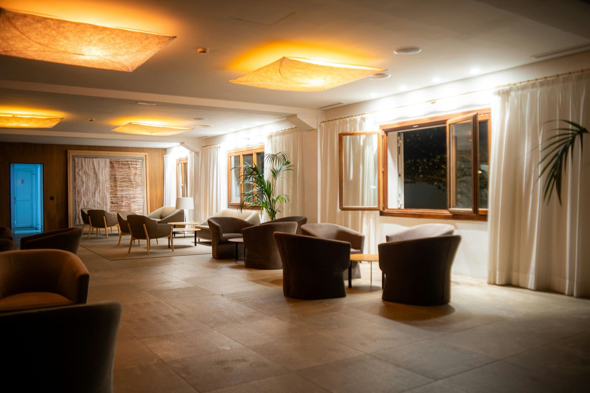Hotel lounge in the evening with warm ceiling lights