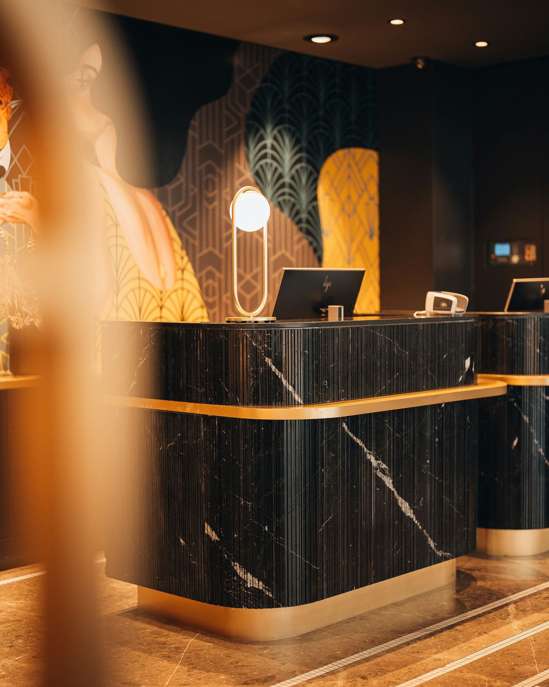 Marble reception desk with a lamp and check-in terminal