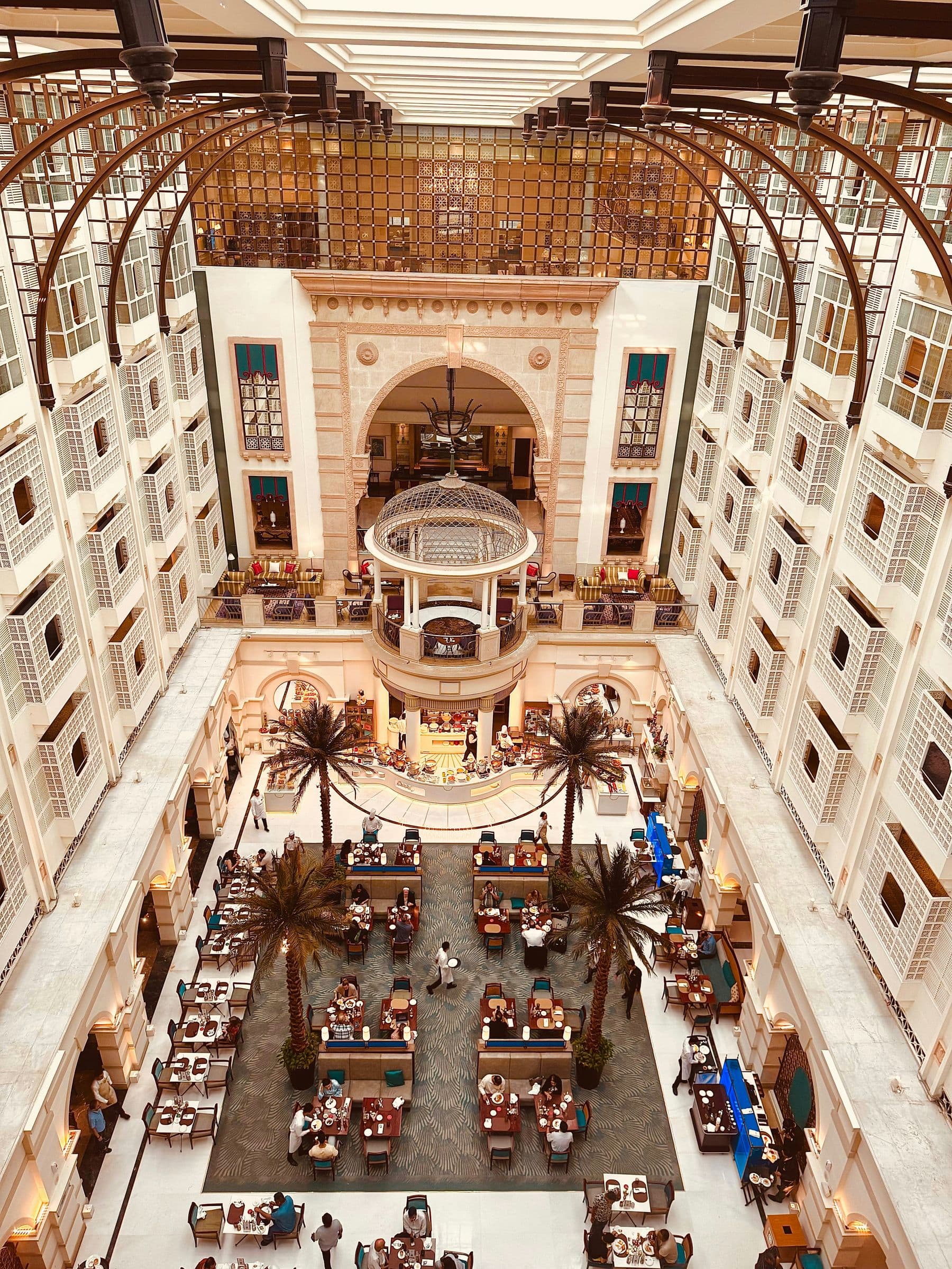 Palace-style hotel atrium with palms and a gazebo