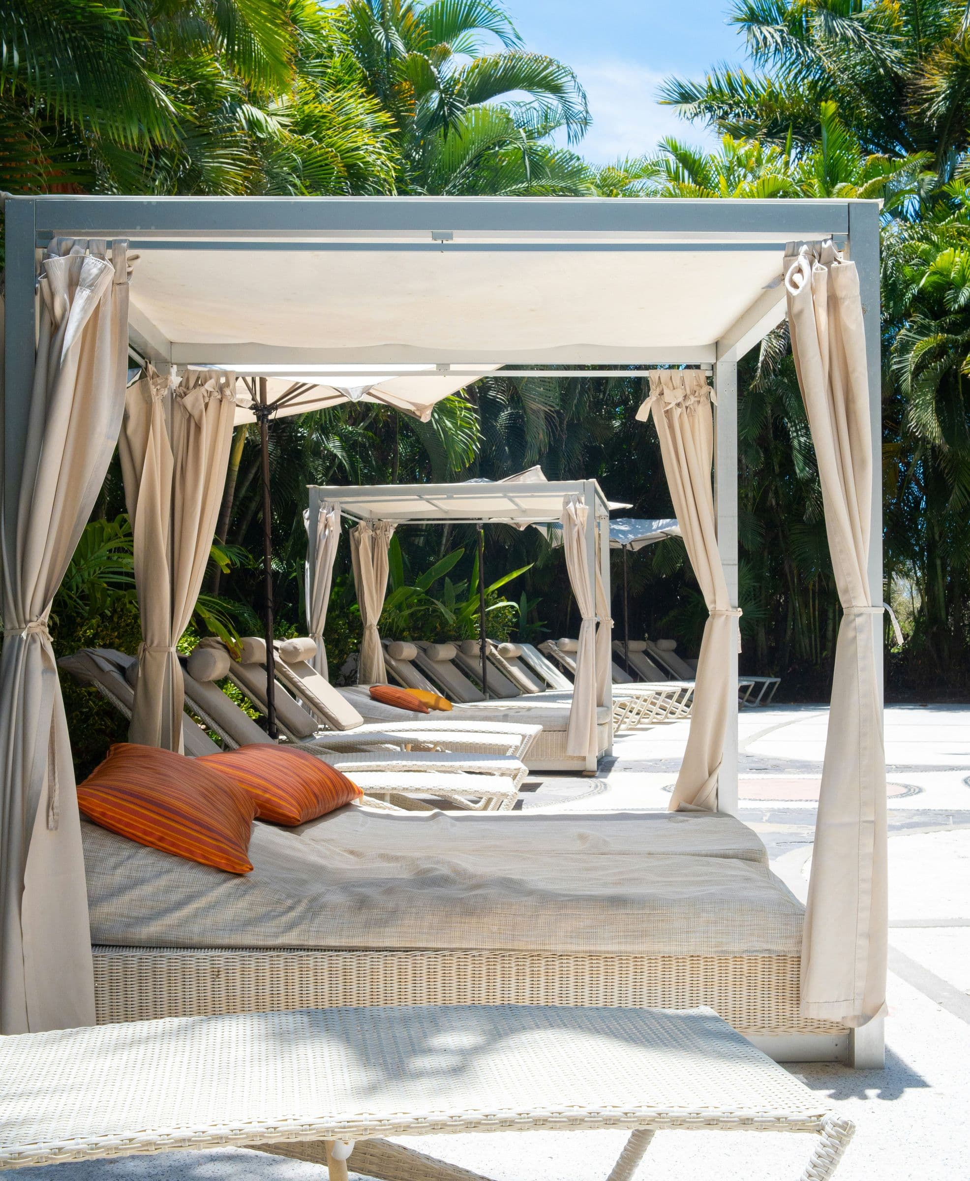 Poolside cabana with white drapes
