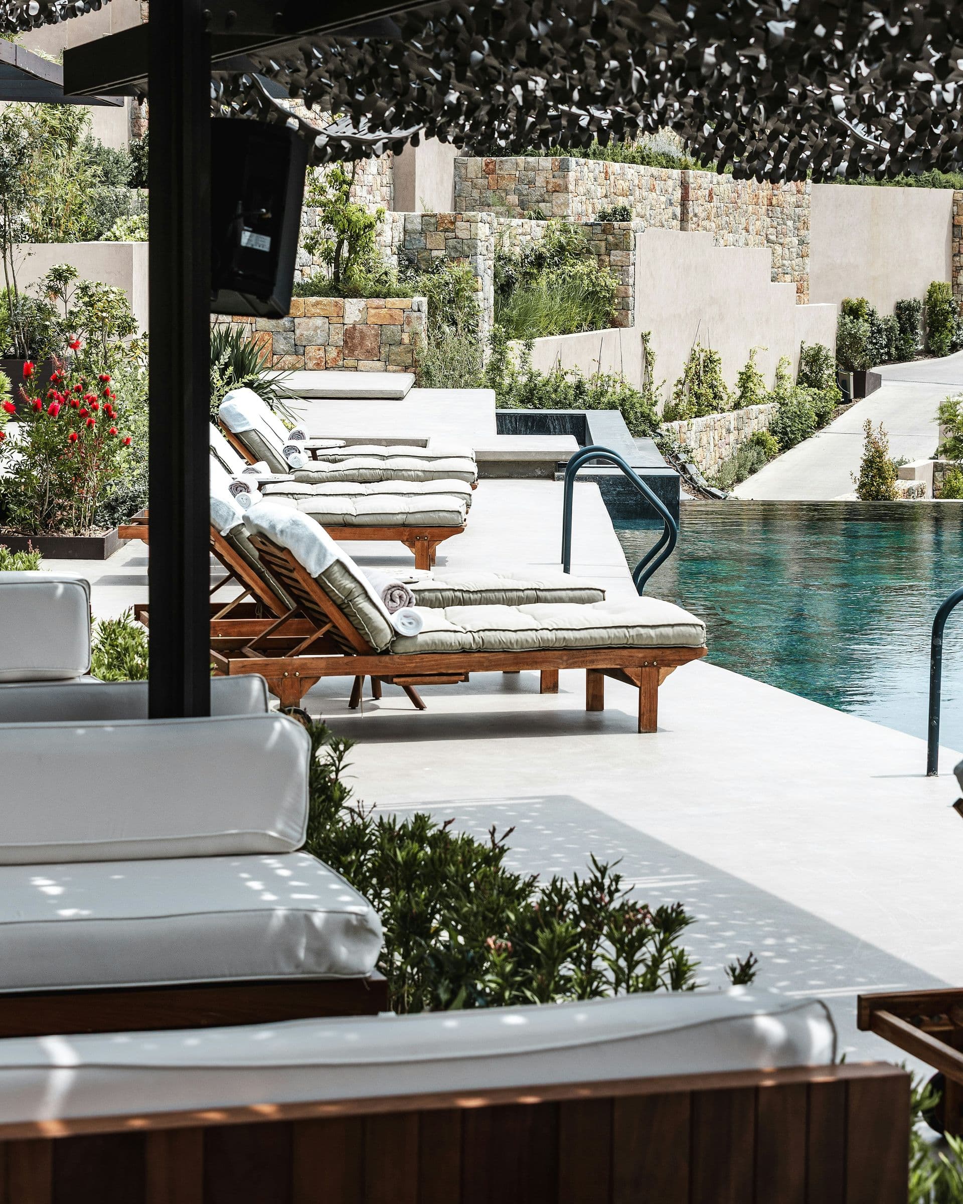 Poolside loungers on a stone terrace
