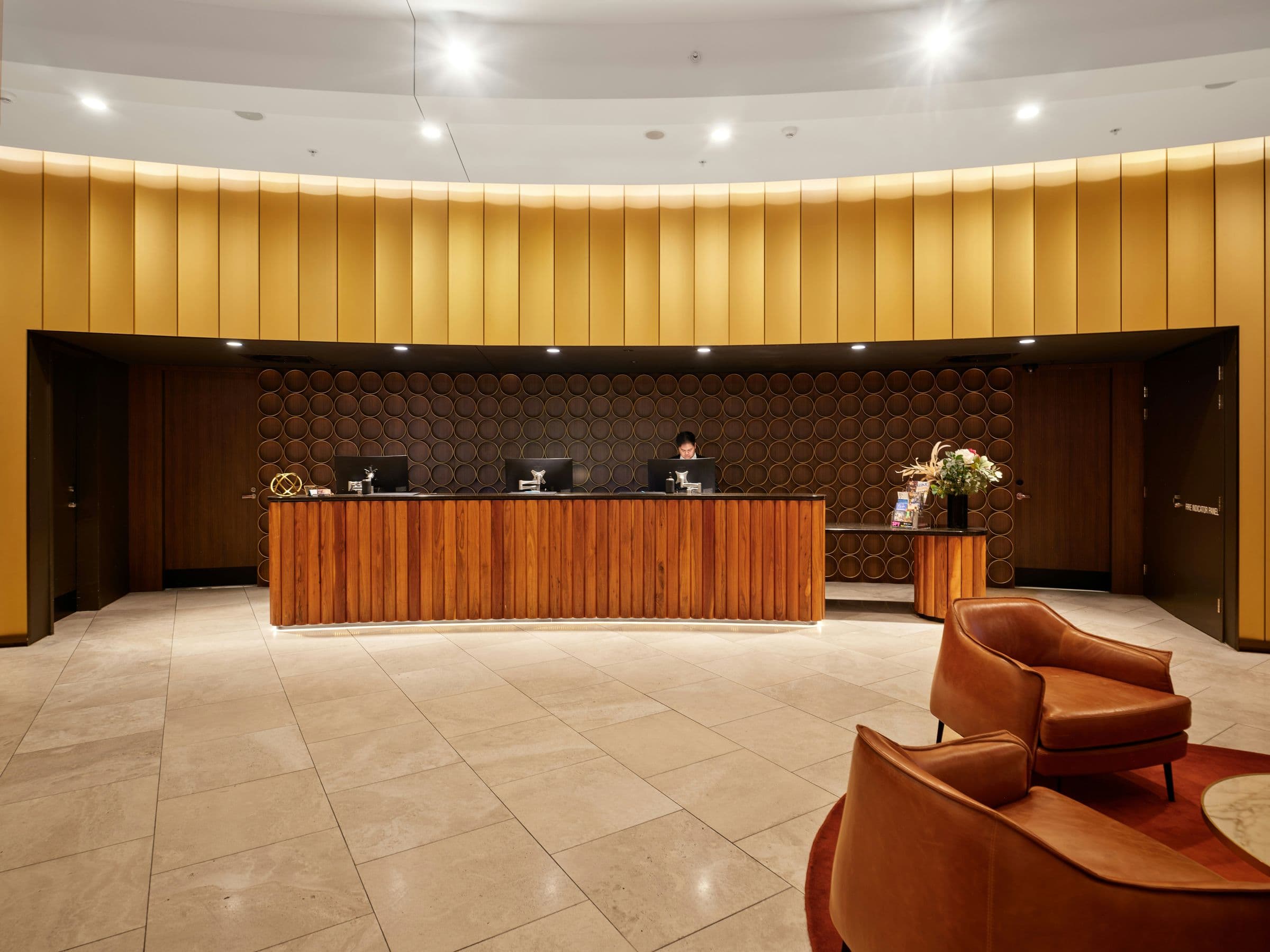 Hotel reception desk against a warm timber wall