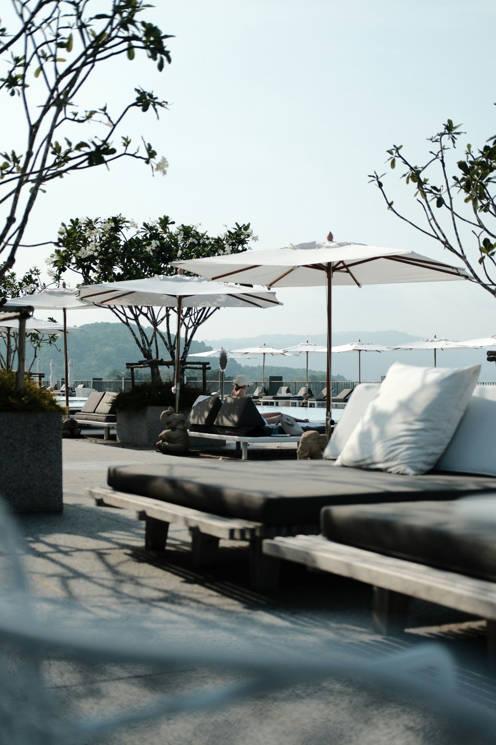 Terrace daybeds under parasols with a sea view