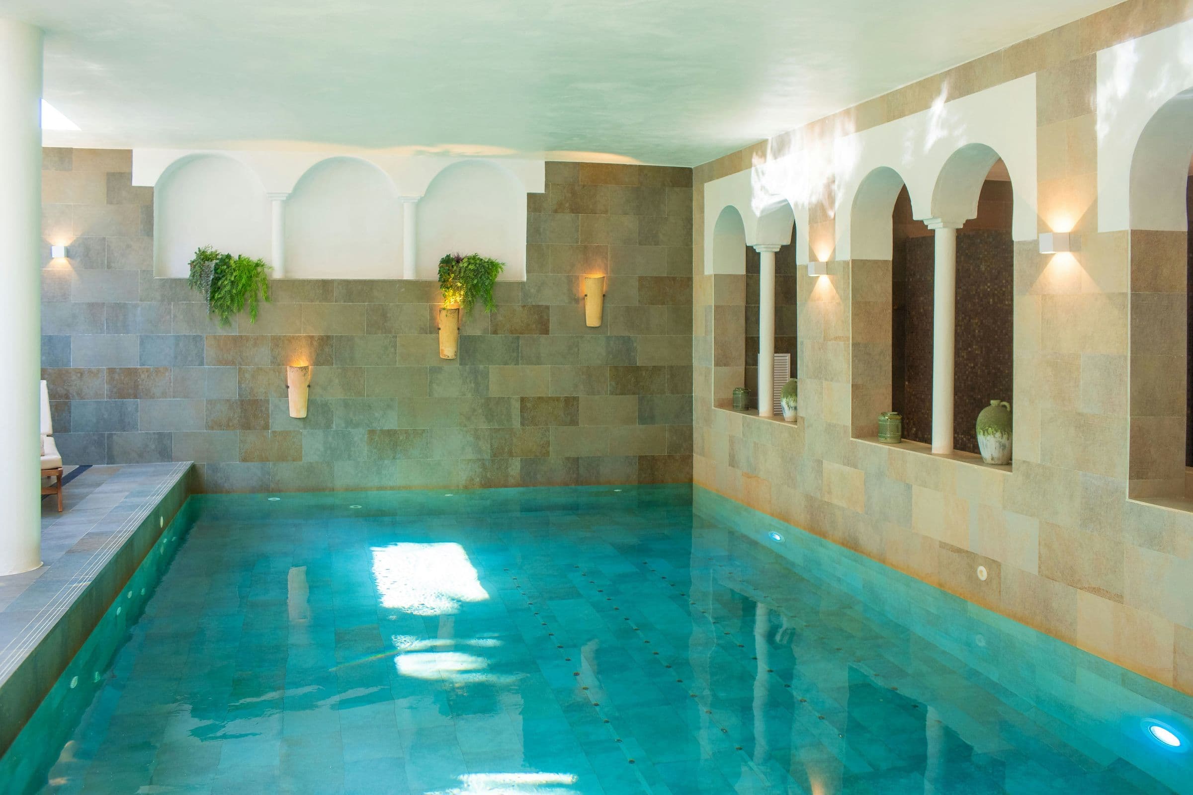 Indoor pool beneath stone arches