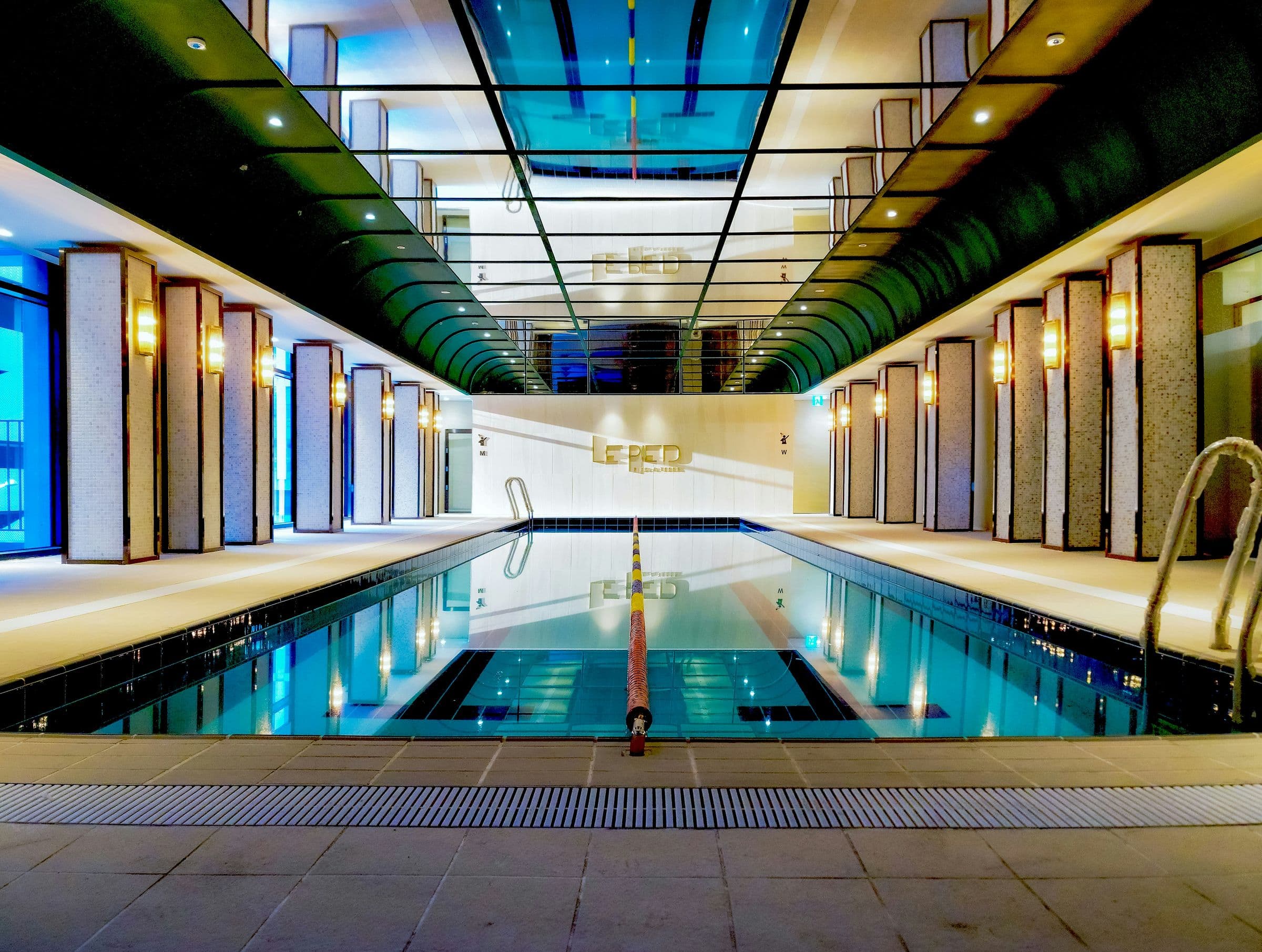 Indoor lap pool under a glass roof