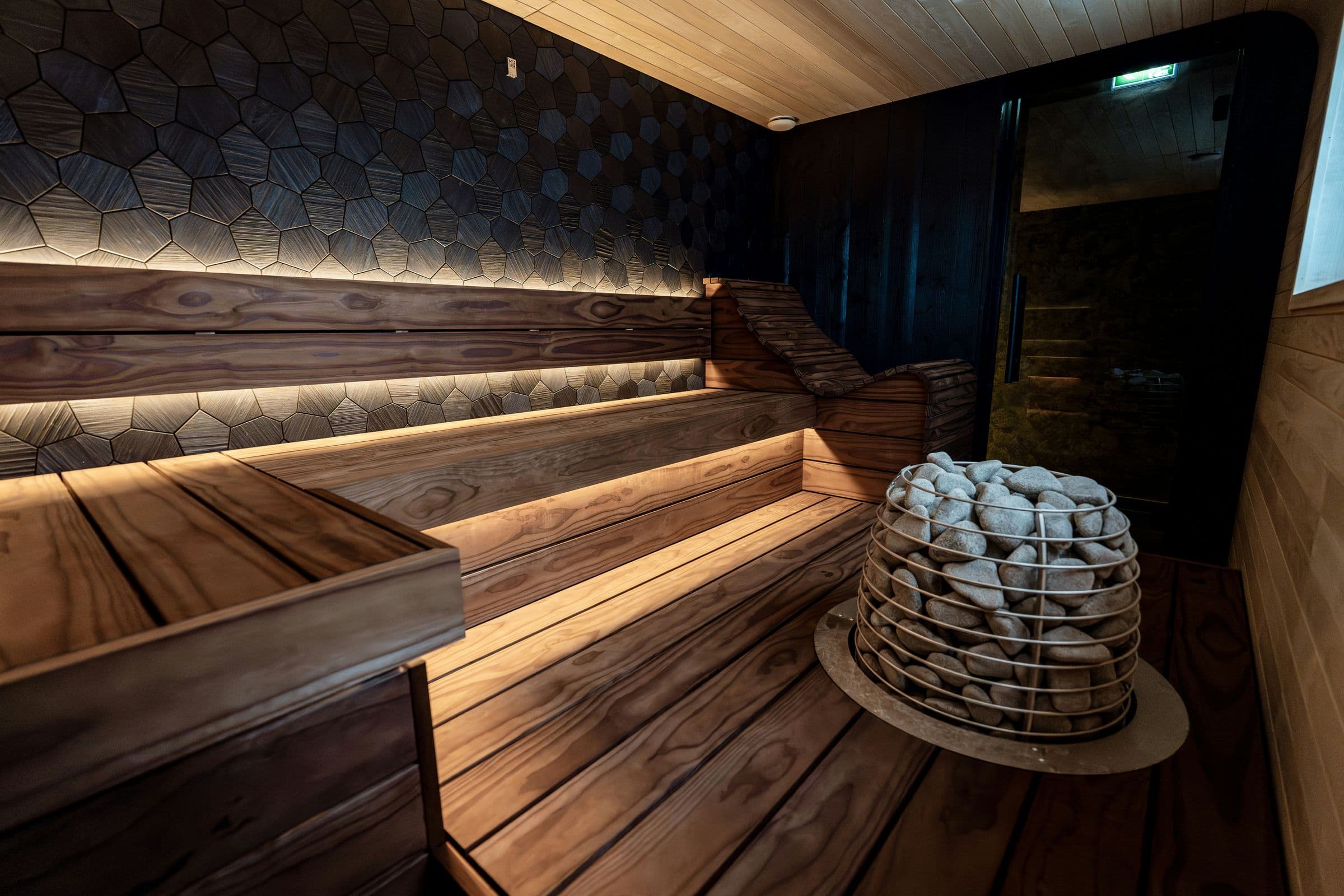 Sauna stone heater in a dark timber cabin