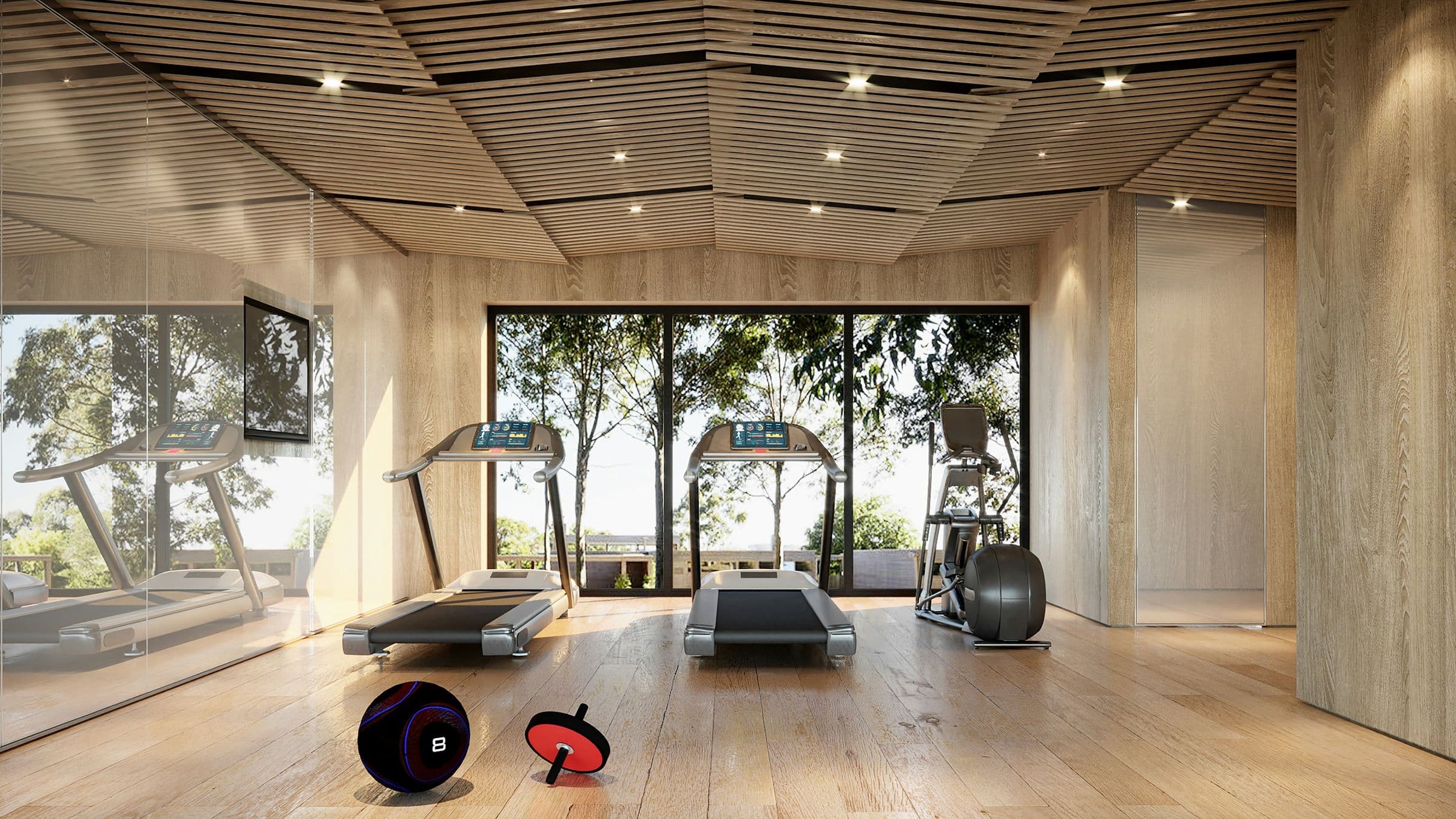 Timber-lined hotel gym with treadmills facing a garden